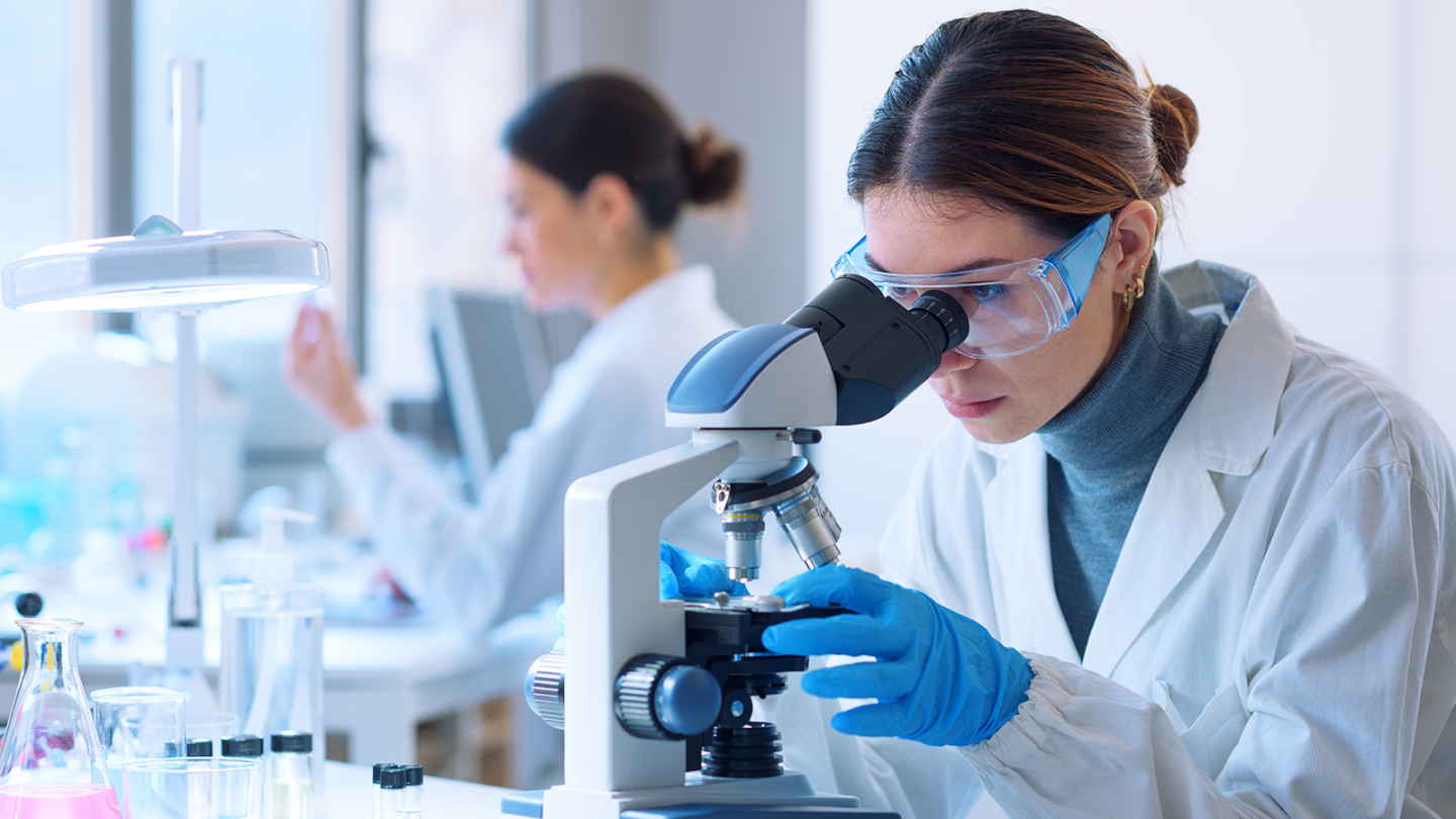 Image of a scientist using a microscope