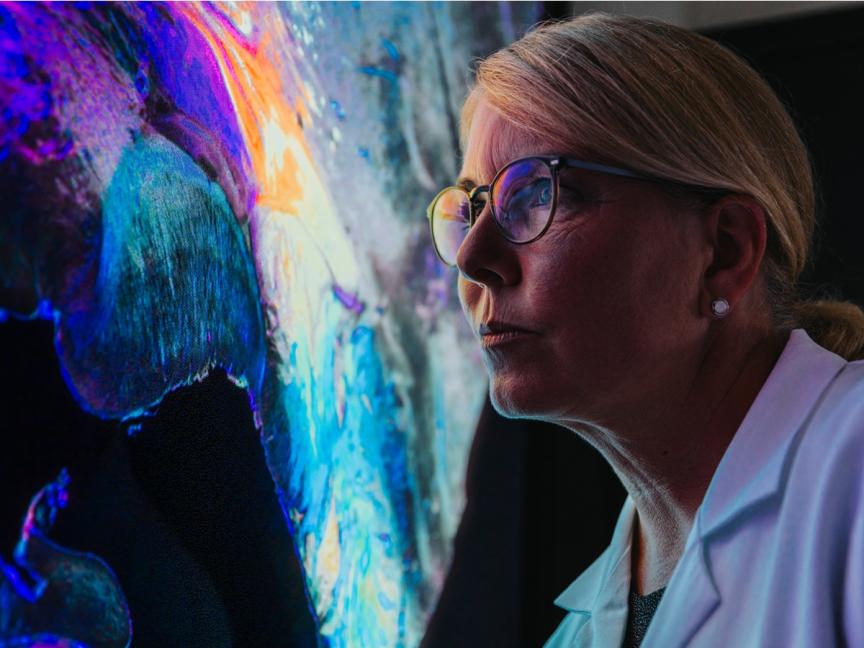 Female researcher looking at a large screen