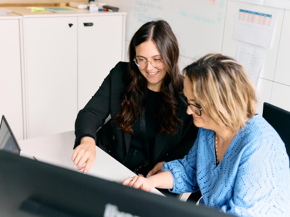 Two staff members of the EBRAINS AISBL working together