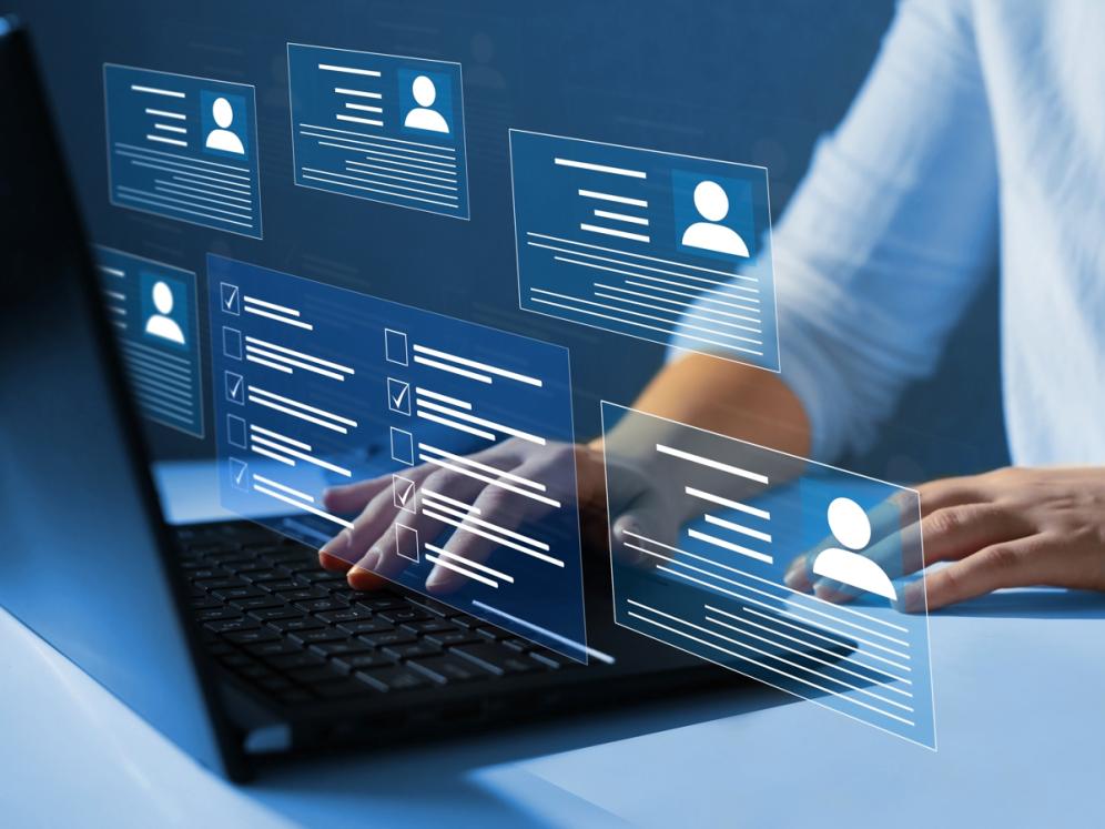 Symbolic image showing someone at a laptop looking at profiles