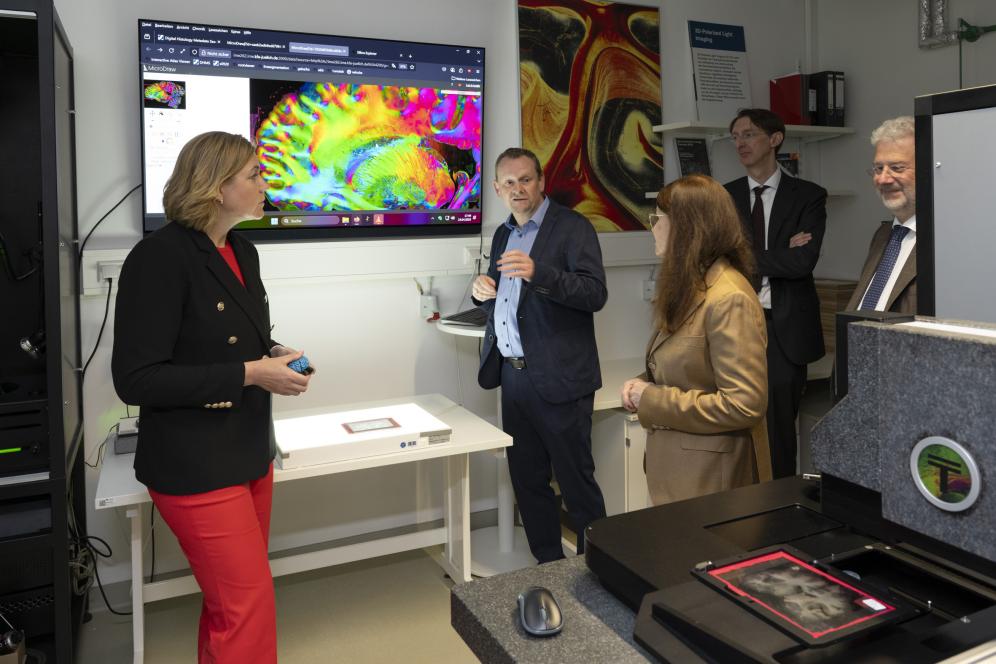 EU Commission Vice President Henna Virkkunen with EBRAINS Joint-CEO Prof. Katrin Amunts and researcher Markus Axer